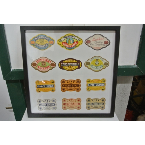 399 - A framed display of various vintage paper labels, to include Maddens & City Bottling Co - Derry.