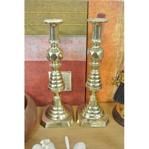 416 - A pair of antique brass candlesticks.