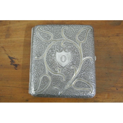 426 - An antique white metal cigarette with case with highly decorative design & gilt interior.