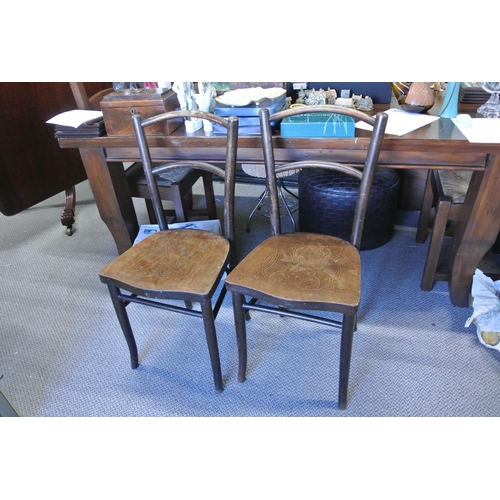 427 - A pair of antique Irish bentwood chairs with decorative deisgn.