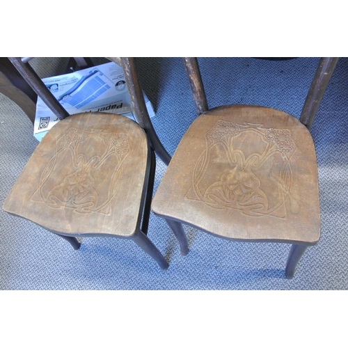 427 - A pair of antique Irish bentwood chairs with decorative deisgn.