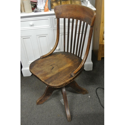 127 - A vintage 1930's wooden office swivel chair.