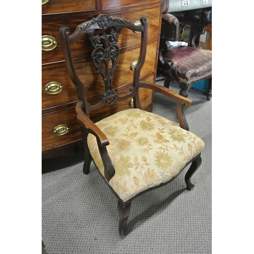 130 - An antique bedroom chair with decorative carved splat.