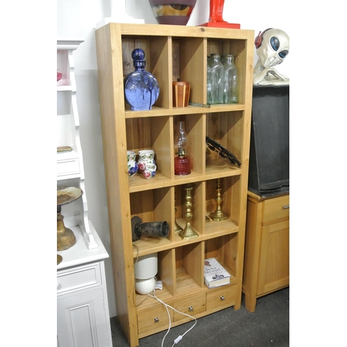 132 - A heavy light oak bookcase.