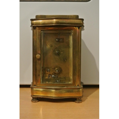 71 - A stunning antique brass serpentine cased carriage clock, dial reading 'Sharman D Neill - Belfast & ... 