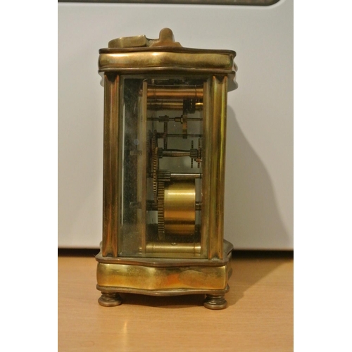 71 - A stunning antique brass serpentine cased carriage clock, dial reading 'Sharman D Neill - Belfast & ... 