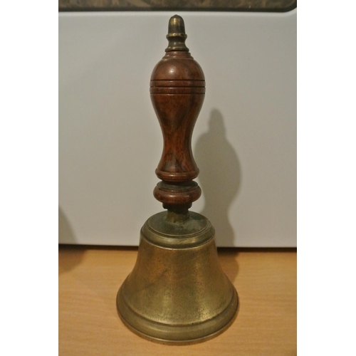 72 - An antique brass school bell with wooden handle.