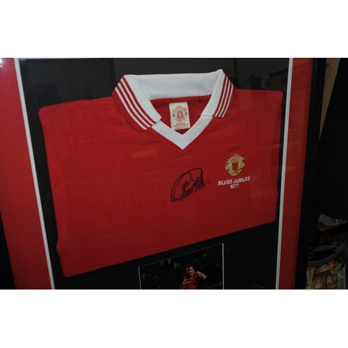 53 - A framed 1977 Manchester United Silver Jubilee shirt, signed by Eric Cantona, with COA.