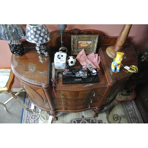 192 - An antique carved sideboard on ball & claw feet, with original key.