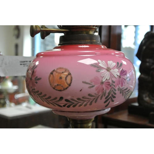 241 - An antique oil lamp on brass Corinthian pillar with hand painted reservoir.