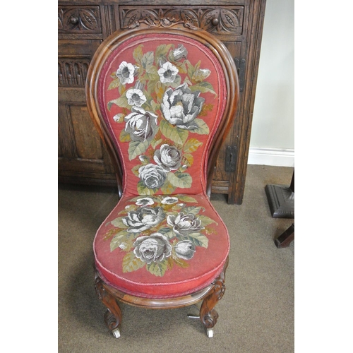 299 - An antique/ Victorian rosewood nursing/ bedroom chair with tapestry upholstery & carved wooden frame... 