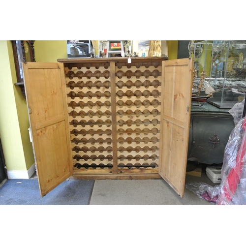 335 - A large pine wine bottle rack/ cupboard.