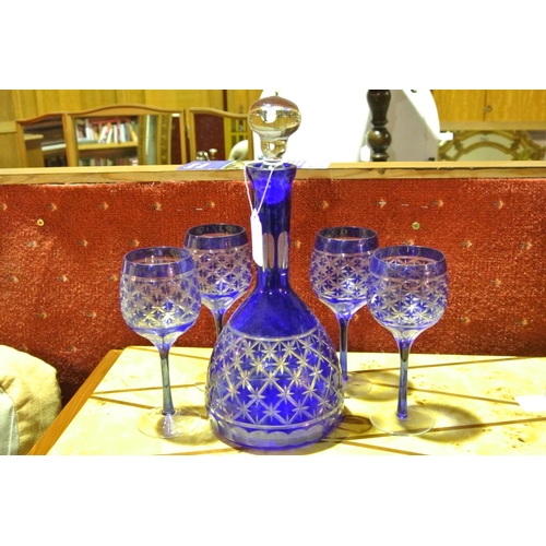 911 - A decorative blue cut glass decanter & set of 4 matching wine glasses.