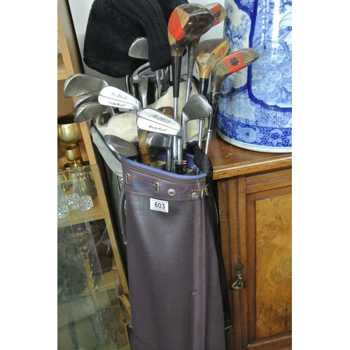 603 - An assortment of various golf clubs.