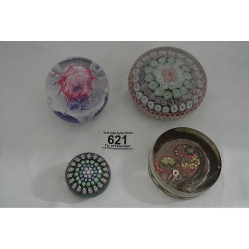 621 - A collection of 4 decorative glass paperweights.