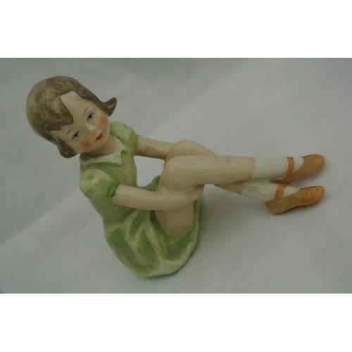 628 - A pair of ceramic figures, modelled as a boy & girl.