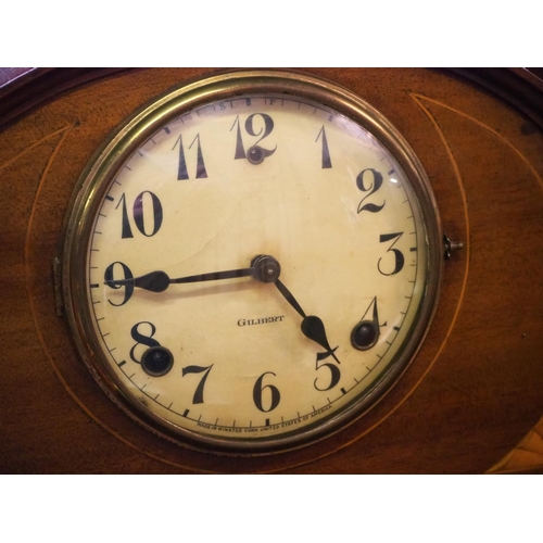 242 - An inlaid antique striking mantle clock, with dial reading 'Gilbert'.