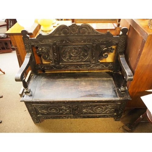 264 - A stunning antique heavily carved monks bench in need of some restoration.