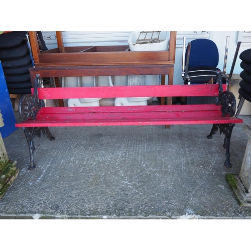 324 - A garden bench with decorative cast iron ends.