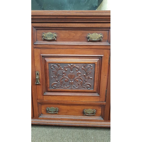 359 - A stunning antique sideboard with decorative carved panels & bevelled mirror back.