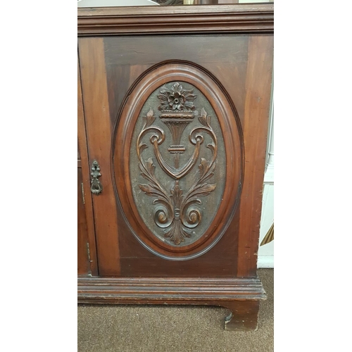 378 - A stunning antique mirror back sideboard with decoratively carved panels.