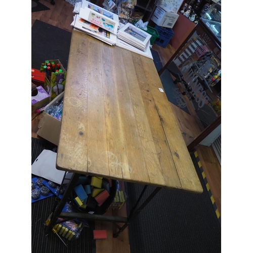 108 - A folding wooden trestle table with metal legs.