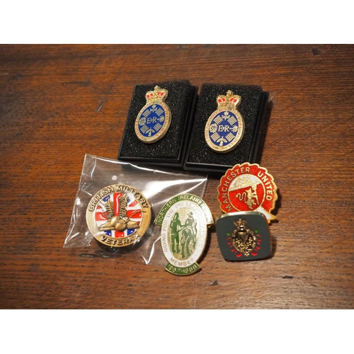 176 - An assortment of pin badges.