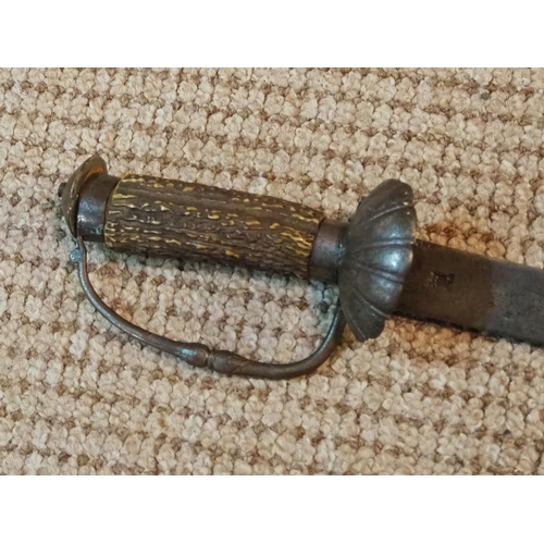 266 - An antique sword with stag antler grip.