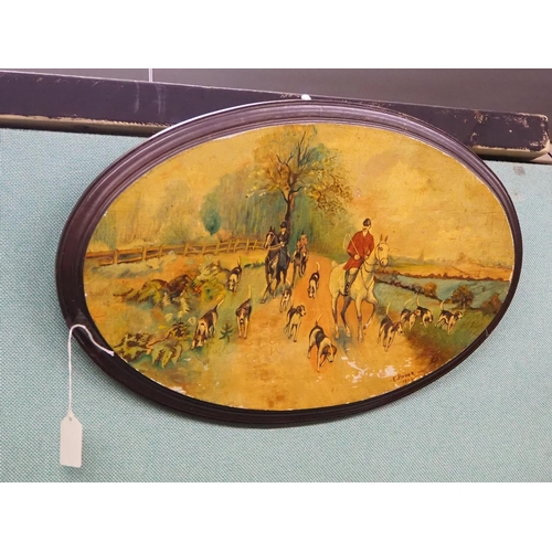 303 - A hand painted wooden plaque showing a hunting scene, signed E Brown.