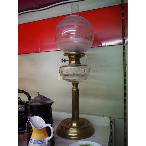 6 - An antique oil lamp on brass base with cut glass font  etched shade.