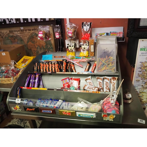 64 - A sweet shop display with contents.