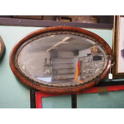 325 - A large antique oval mirror.