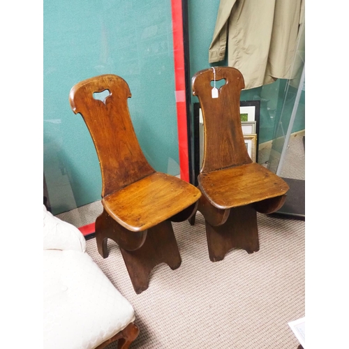 329 - A pair of decorative antique wooden hall chairs.