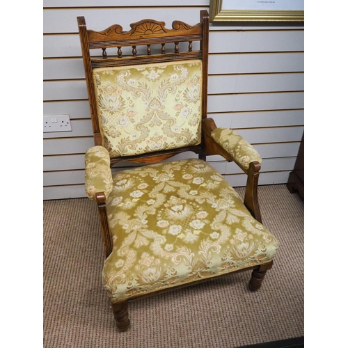 399 - An antique armchair with carved wooden frame.