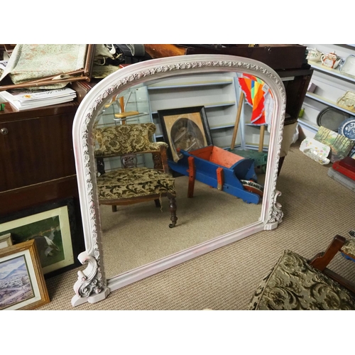 402 - A large arch top over mantle mirror with decorative frame.