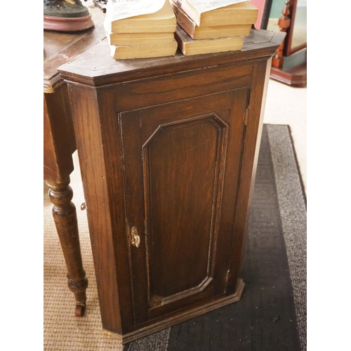 416 - An antique wall mounted corner cabinet.