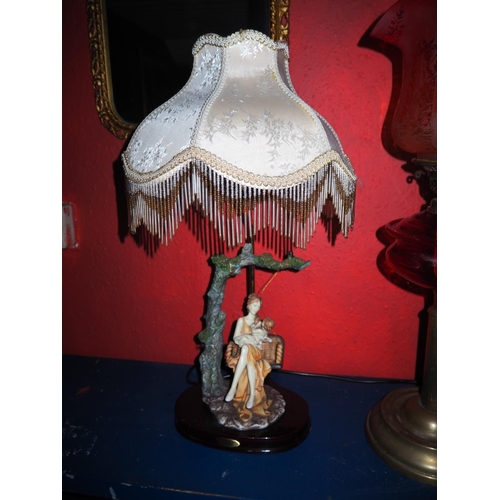 574 - A decorative table lamp with shade.