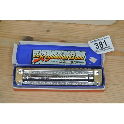 A Hohner Regulation Band harmonica in original box.
