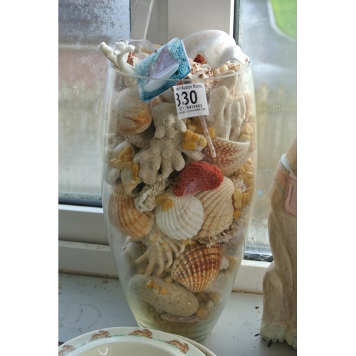330 - A large lot of decorative seas shells in glass vase