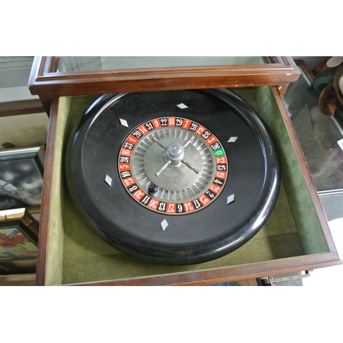 388 - An oak cased tabletop Roulette Wheel along with mat and chips