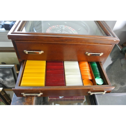 388 - An oak cased tabletop Roulette Wheel along with mat and chips