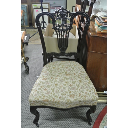 724 - A nicely carved back mahogany chair on casters