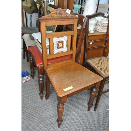 727 - An oak framed chair with tile detail on back