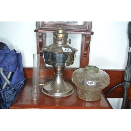 747 - A chrome based oil lamp with clear glass globe