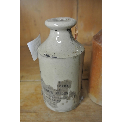 763 - A pair of stoneware bottles. One with part label