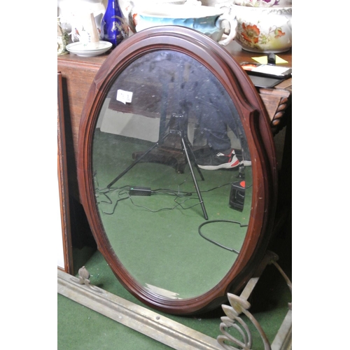 781 - An oval mahogany mirror