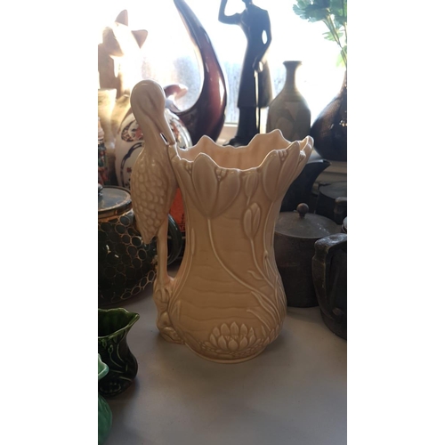 327 - A tan Sylvac Heron handle water Jug