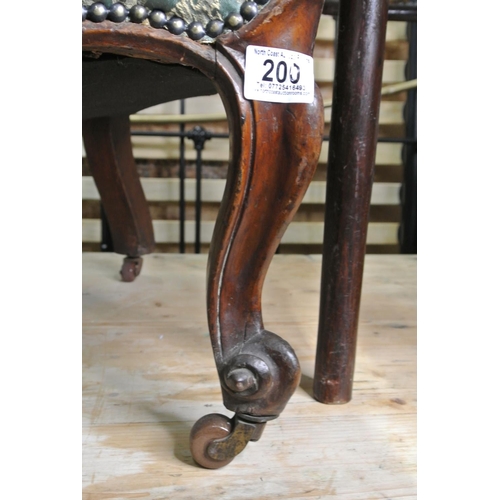 200 - A stunning antique mahogany upholstered chair on casters.