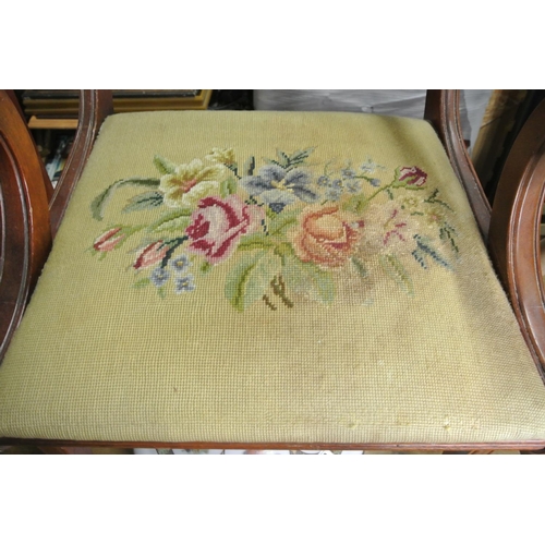 210 - An antique carver chair with tapestry upholstery