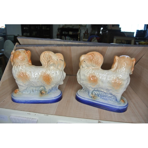 76 - A pair of antique ceramic Pekingese Dogs on blue bases.